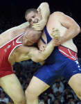 Alexander Kareline (L) struggles battles Rulon Gardner in the 130 kg division. REUTERS/Oleg Popov 